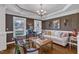 Comfortable living room with wooden floors, bright windows, and relaxed seating at 212 Fieldtrial Cir, Garner, NC 27529