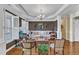 Cozy living room features a white sofa, wood flooring, and elegant chandelier at 212 Fieldtrial Cir, Garner, NC 27529