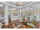 Bright living room with tray ceiling and white pillars open to a dining area at 212 Fieldtrial Cir, Garner, NC 27529