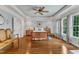 Spacious main bedroom featuring hardwood floors, tray ceiling, and large windows with backyard views at 212 Fieldtrial Cir, Garner, NC 27529