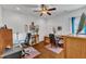 Bright and airy office with hardwood floors, two large chairs, desks, and a ceiling fan at 212 Fieldtrial Cir, Garner, NC 27529