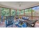 Inviting screened-in porch with comfortable wicker furniture and a serene outdoor view at 212 Fieldtrial Cir, Garner, NC 27529