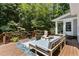 Cozy outdoor living space with comfortable lounge furniture, a fire pit, and a lush tree backdrop at 215 Collinson Dr, Chapel Hill, NC 27514