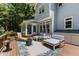 Inviting back deck with comfortable seating, a modern fire pit, and access to the home's sunroom at 215 Collinson Dr, Chapel Hill, NC 27514