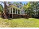 Expansive backyard featuring a covered porch and stairs that seamlessly blend indoor and outdoor living spaces at 215 Collinson Dr, Chapel Hill, NC 27514