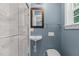 Compact bathroom features a wall mounted sink and a modern toilet at 215 Collinson Dr, Chapel Hill, NC 27514