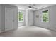 Neutral bedroom features a ceiling fan and lots of natural light at 215 Collinson Dr, Chapel Hill, NC 27514