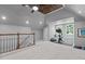 Large finished bonus room with tray ceiling, with a built-in bench under a window at 215 Collinson Dr, Chapel Hill, NC 27514
