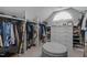 Spacious walk-in closet with custom shelving and an ottoman at 215 Collinson Dr, Chapel Hill, NC 27514