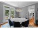Dining room with a marble table, chandelier, French doors, and views of outdoor seating area at 215 Collinson Dr, Chapel Hill, NC 27514