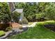 Pathway leading to a house with meticulous landscaping, including brick steps and dark mulch at 215 Collinson Dr, Chapel Hill, NC 27514