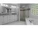 Bright main bathroom with double vanity, soaking tub and glass shower at 215 Collinson Dr, Chapel Hill, NC 27514