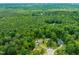 Expansive aerial view of homes nestled within a lush green, wooded landscape at 215 Virginia Pine Dr, Clayton, NC 27520