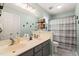 Bathroom with double sinks, a large mirror, and a shower-tub combo with a decorative shower curtain at 215 Virginia Pine Dr, Clayton, NC 27520