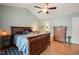 Cozy bedroom with a wooden bed frame, vaulted ceilings, and hardwood floors at 215 Virginia Pine Dr, Clayton, NC 27520