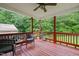Relaxing covered deck with wooden flooring, railing, wicker chairs, and a ceiling fan at 215 Virginia Pine Dr, Clayton, NC 27520