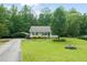 Charming single-story home with a well-maintained lawn, cozy porch, and convenient carport at 215 Virginia Pine Dr, Clayton, NC 27520