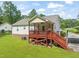 Exterior view of a two-story home with a covered deck, green lawn, and mature trees at 215 Virginia Pine Dr, Clayton, NC 27520