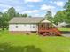 Exterior view of a two-story home with a covered deck, green lawn, and mature trees at 215 Virginia Pine Dr, Clayton, NC 27520