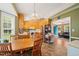 Kitchen featuring wood cabinets, stainless steel appliances, and an adjacent dining area with a chandelier at 215 Virginia Pine Dr, Clayton, NC 27520