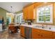 Bright kitchen with stainless steel appliances and a dining area featuring a chandelier and exterior view at 215 Virginia Pine Dr, Clayton, NC 27520