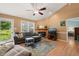 Bright living room with hardwood floors, a fireplace, and access to the backyard at 215 Virginia Pine Dr, Clayton, NC 27520