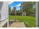 Private backyard with lush green grass and storage shed at 2423 Northern Bnd, Burlington, NC 27217