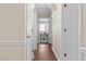 Hallway featuring hardwood floors, white trim, and several doors leading to different rooms at 2423 Northern Bnd, Burlington, NC 27217