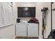 Functional laundry room with washer, dryer, storage cabinets, and convenient hooks at 2423 Northern Bnd, Burlington, NC 27217