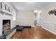 Bright living room with hardwood floors and a white brick fireplace for a cozy space at 2423 Northern Bnd, Burlington, NC 27217