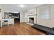 Cozy living room featuring a brick fireplace, hardwood floors, and natural light from the window at 2423 Northern Bnd, Burlington, NC 27217