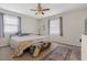 Serene main bedroom with natural light, ceiling fan, area rug and neutral decor at 2423 Northern Bnd, Burlington, NC 27217