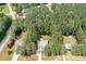 Aerial view of a neighborhood showcasing tree-lined streets and well-maintained homes with private yards at 25 Spicetree Ct, Youngsville, NC 27596