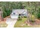 Picturesque aerial view of the home, showcasing its position amidst lush greenery and mature trees at 25 Spicetree Ct, Youngsville, NC 27596