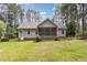 Backyard view of house with screened porch and partial wood fence surrounding the yard at 25 Spicetree Ct, Youngsville, NC 27596