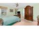Spacious bedroom with a decorative wardrobe, TV, and an attached bathroom at 25 Spicetree Ct, Youngsville, NC 27596