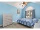 Bedroom features blue walls, vaulted ceiling, ceiling fan, and window with arched transom at 25 Spicetree Ct, Youngsville, NC 27596
