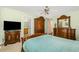 Primary bedroom features wooden furniture, a ceiling fan, and neutral carpet at 25 Spicetree Ct, Youngsville, NC 27596