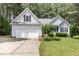Charming single-Gathering home with an attached garage, lush landscaping, and a well-manicured lawn at 25 Spicetree Ct, Youngsville, NC 27596