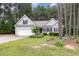 Well-maintained home featuring a two-car garage, charming landscaping, and a welcoming facade at 25 Spicetree Ct, Youngsville, NC 27596