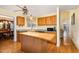 Eat-in kitchen area offers stainless appliances, wood cabinets, and a functional center island at 25 Spicetree Ct, Youngsville, NC 27596