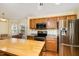 Spacious kitchen with stainless steel appliances, wooden cabinets, and a large butcher block island at 25 Spicetree Ct, Youngsville, NC 27596