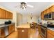 Bright eat-in kitchen with wooden cabinets, stainless steel appliances, hardwood floors, and a butcher block island at 25 Spicetree Ct, Youngsville, NC 27596