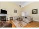 Inviting living room featuring a cozy fireplace, large sofa, and view of an open floor plan at 25 Spicetree Ct, Youngsville, NC 27596
