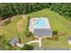 Aerial view of community pool area with sun loungers, tables, clubhouse, landscaping, and parking at 25 Spicetree Ct, Youngsville, NC 27596