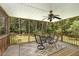 Relaxing screened porch with ceiling fan and views of a private, wooded backyard at 25 Spicetree Ct, Youngsville, NC 27596