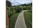 A backyard featuring a walkway with a shrub, lawn, and privacy fence at 2511 Dalmahoy Ln, Fuquay Varina, NC 27526