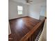 This bedroom has hardwood floors, a ceiling fan, and a window that provides natural light with nice views at 2511 Dalmahoy Ln, Fuquay Varina, NC 27526