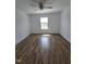 A spacious bedroom with wood-style flooring and a window providing natural light at 2511 Dalmahoy Ln, Fuquay Varina, NC 27526