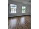This bedroom has wood floors and two windows that let in an abundance of light at 2511 Dalmahoy Ln, Fuquay Varina, NC 27526